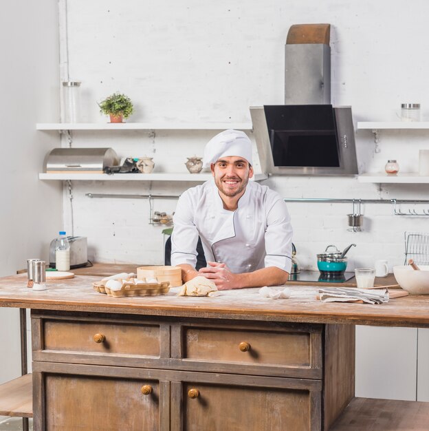 Chef in kitchen making dough