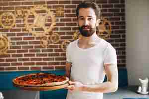 Free photo chef in the kitchen prepares pizza