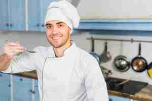 Free photo chef in kitchen with spoon