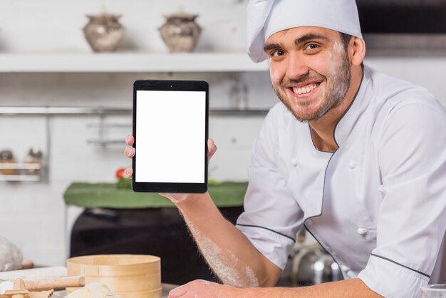 Chef in kitchen with tablet screen template
