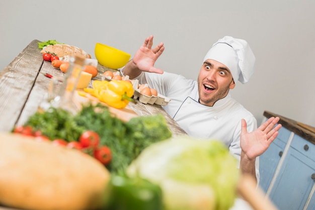 Chef in kitchen with vegetables