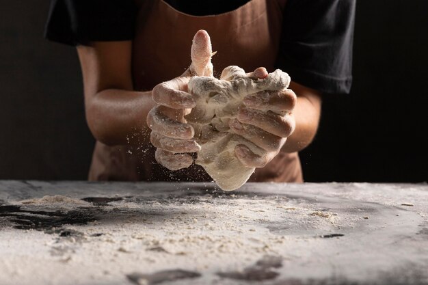 Chef kneading dough in hands