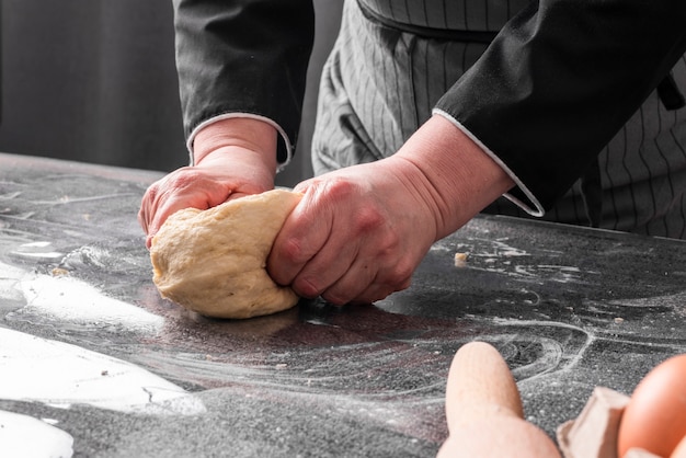 Chef kneading dough