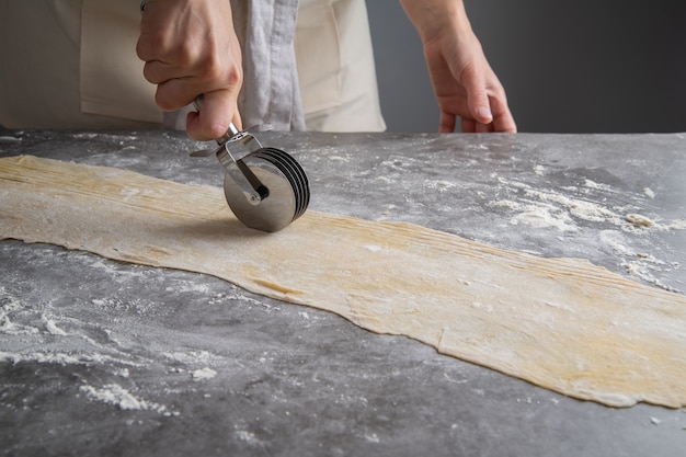 Free photo chef making pasta out of dough