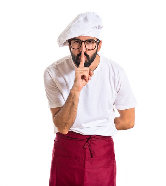 Chef making silence gesture over white background