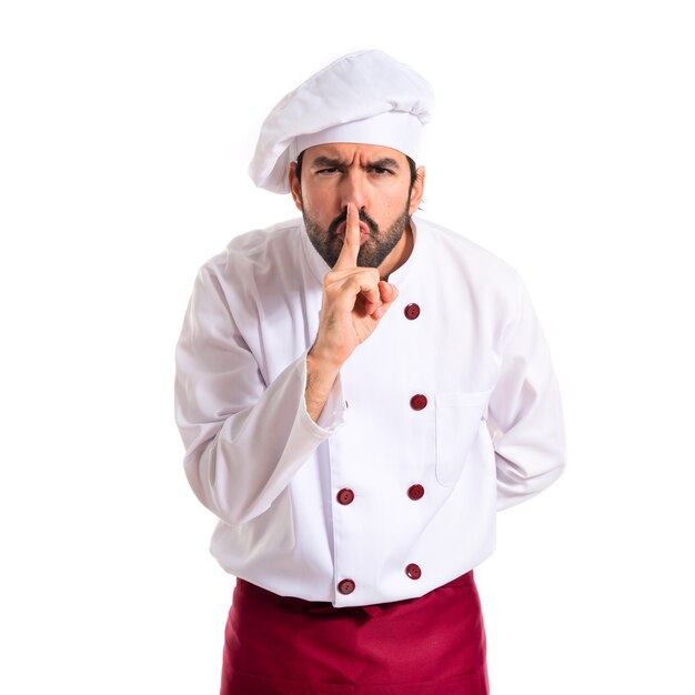 Chef making silence gesture over white background