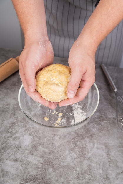 Chef molding dough with both hands