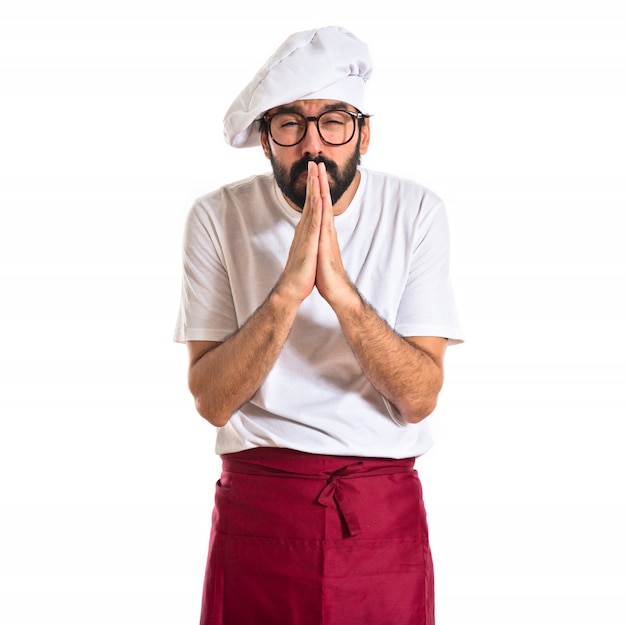 Free photo chef pleading over white background