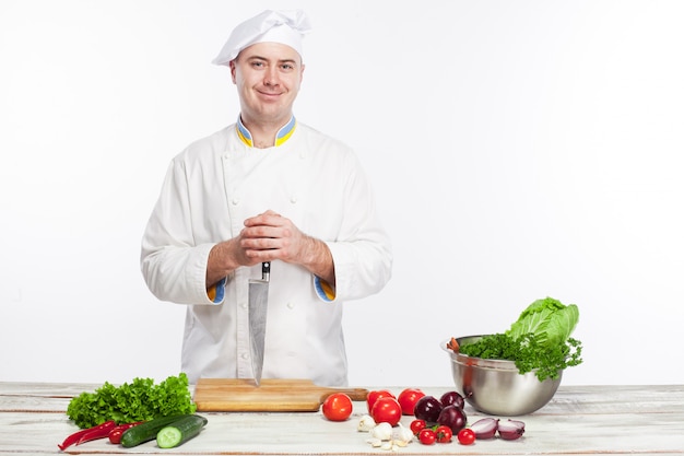 Chef posing with knife in his kitchen