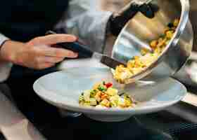 Free photo chef pouring food on plate