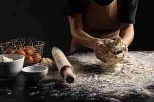 Free photo chef preparing bread dough on table