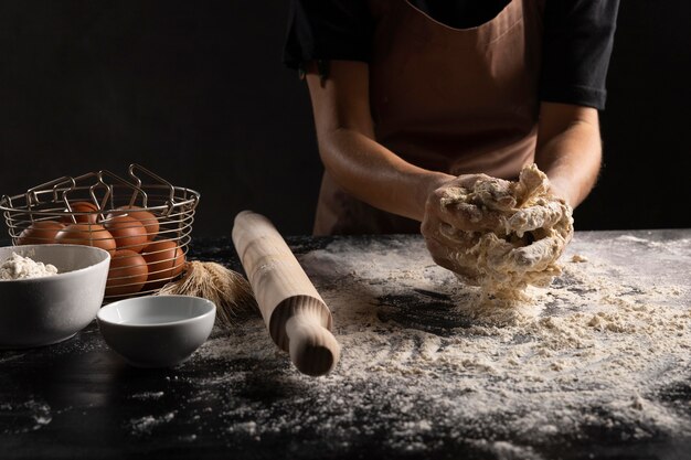 Chef preparing bread dough on table