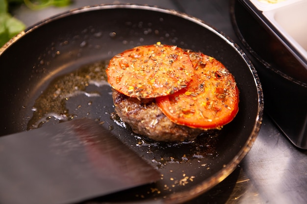 Chef preparing delicious burger meat. In restaurant