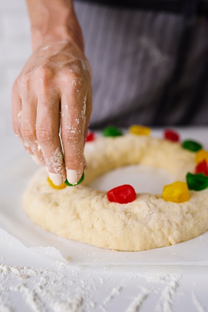 Chef preparing epiphany day dessert with sweet candy