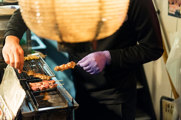 Free photo chef preparing tasty japanese food on the grill