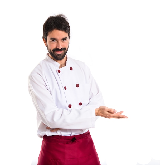 Chef presenting something over white background