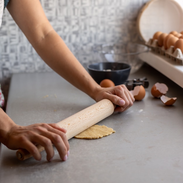 Chef pressing dough