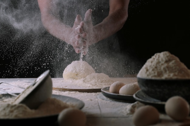 Chef in the process of making a pizza dough