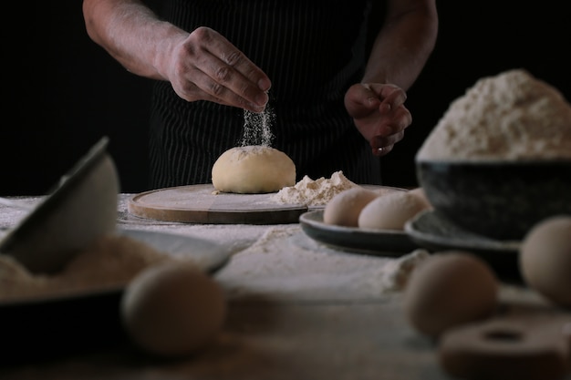 Chef in the process of making a pizza dough