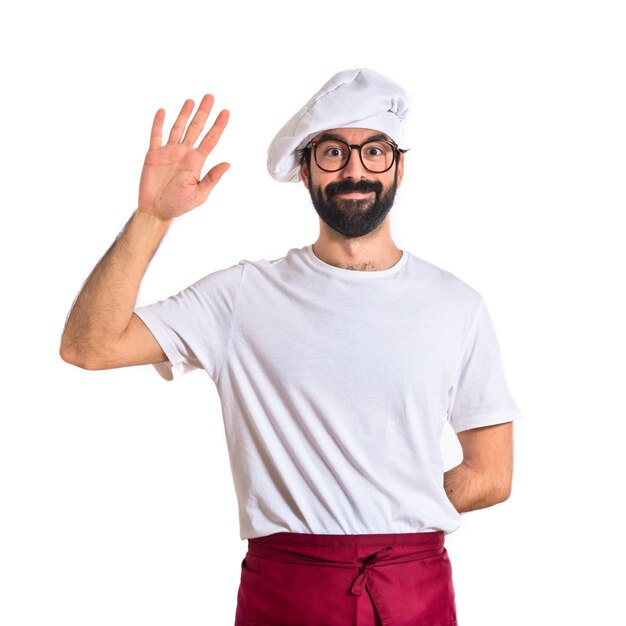 Chef saluting over white background