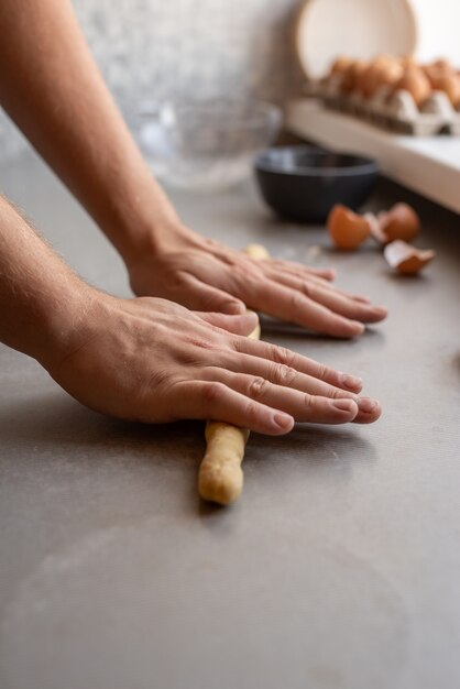 Chef shaping dough with both hands