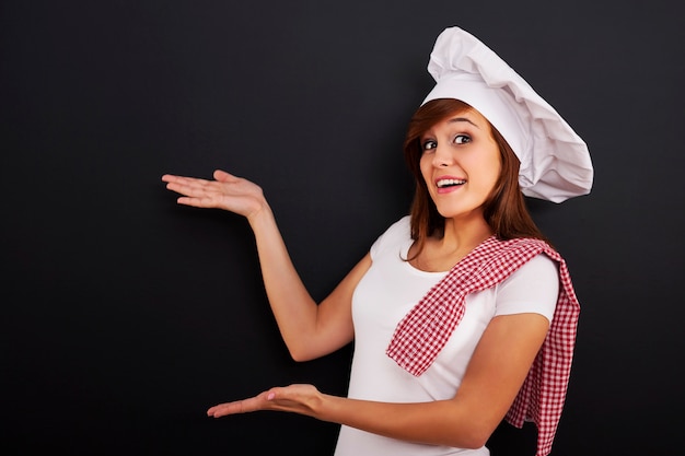 Chef showing blank menu on blackboard