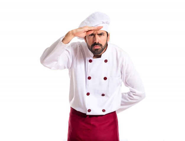 Chef showing something over white background