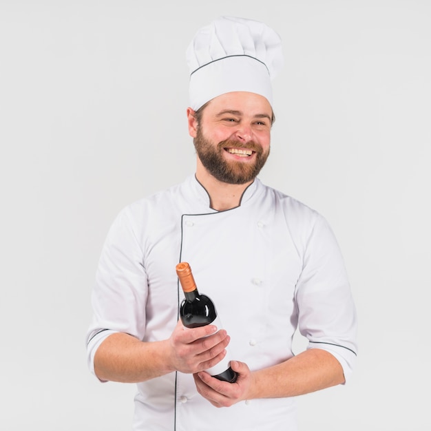 Chef smiling with bottle of wine 