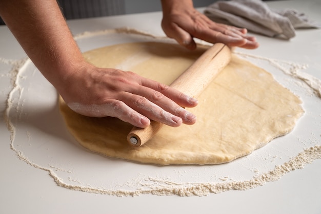 Chef stratching dough in flour