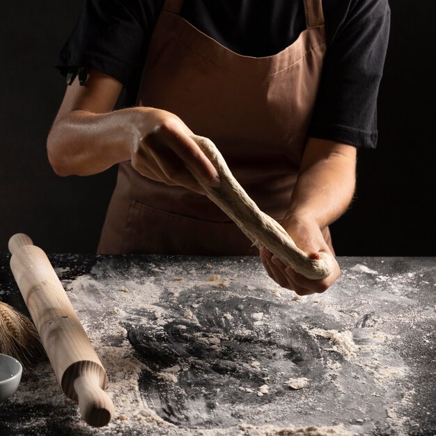 Chef stretching dough with hands