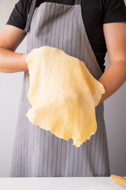 Chef stretching pasta dough