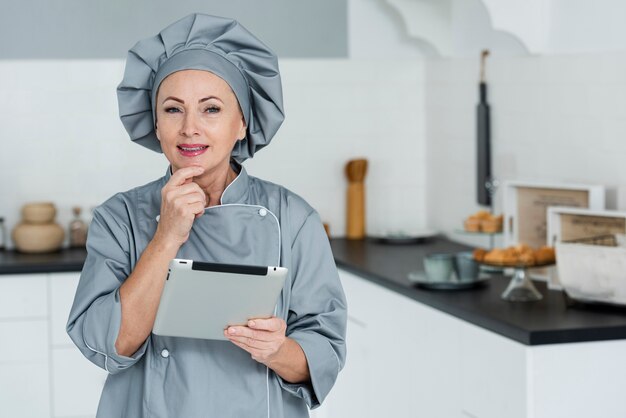 Chef with clipboard in kitchen