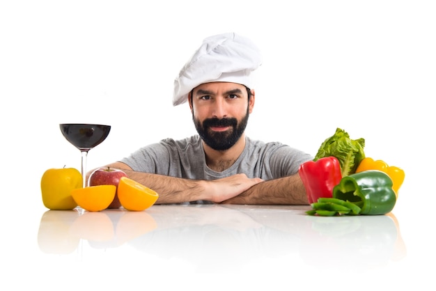 Free photo chef with several vegetables and fruits on table