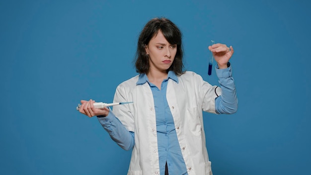 Free photo chemistry researcher dripping substance in test tube with micro pipette, using laboratory equipment to work on microbiology and science experiment. chemical scientist analyzing liquid.