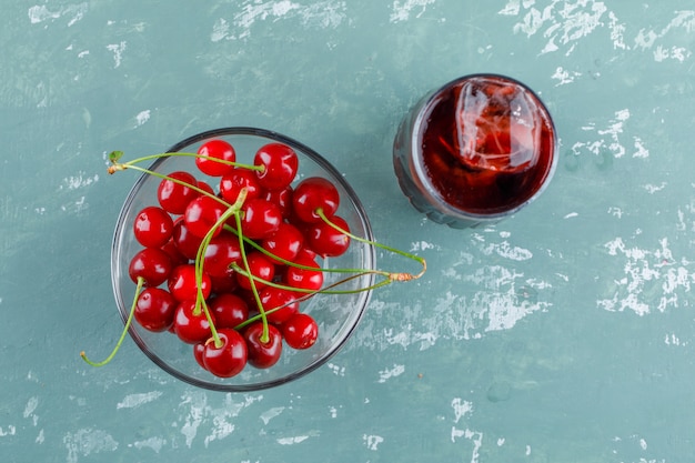 Cherries in a bowl with juice flat lay