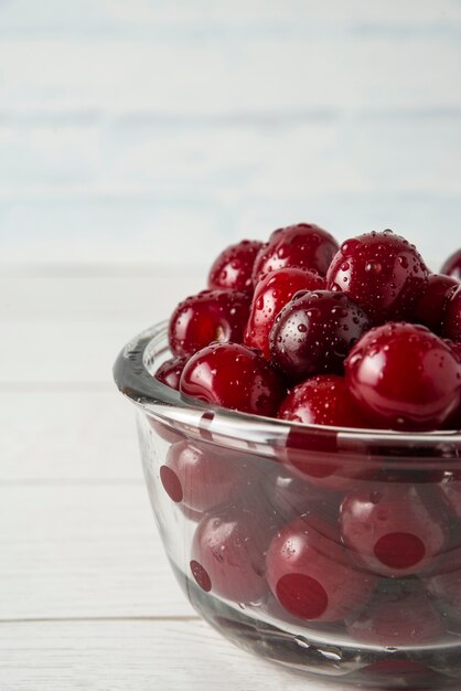 Cherries in a glass bowl isolated on white