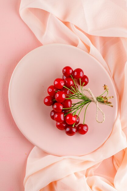 Cherries in a plate flat lay