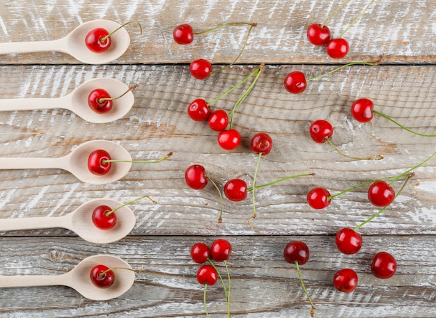 Cherries in wooden spoons on wooden