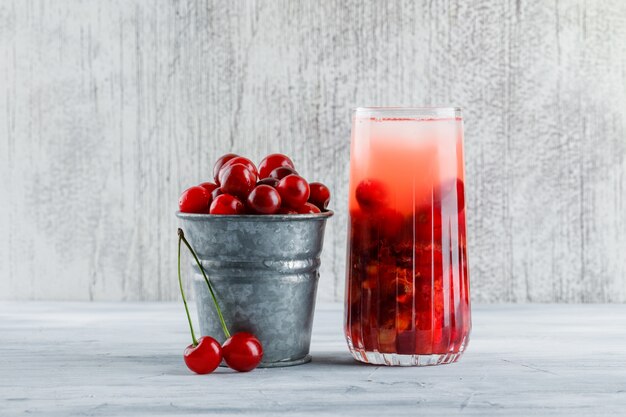 Cherry cocktail in a jug with cherries