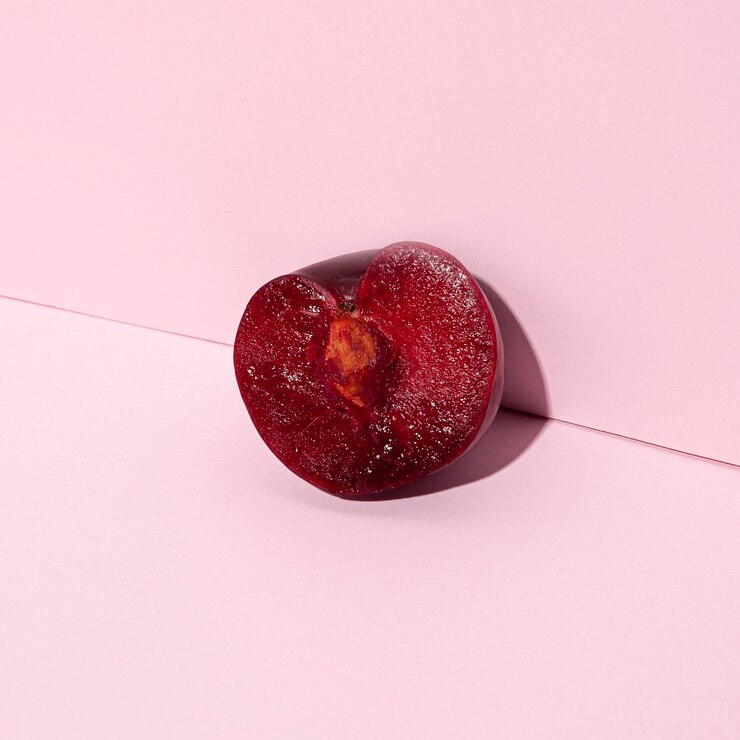 Free Photo cherry half on pink background