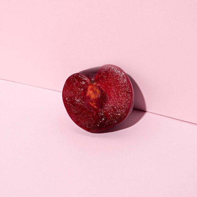 Cherry half on pink background