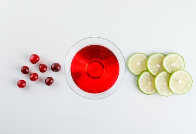 Cherry juice in a glass with cherries, lemon slices on a white