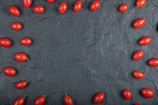 Cherry tomatoes on the black background. High quality photo