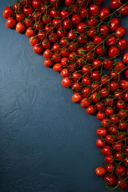 Cherry tomatoes over blue surface