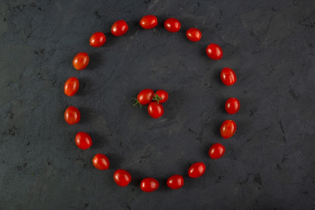 Cherry tomatoes fresh ripe mellow vitamine riched round shaped little red cherry tomatoes on dark desk
