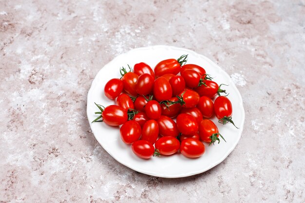 Cherry tomatoes of various colors,yellow and red cherry tomatoes on light background