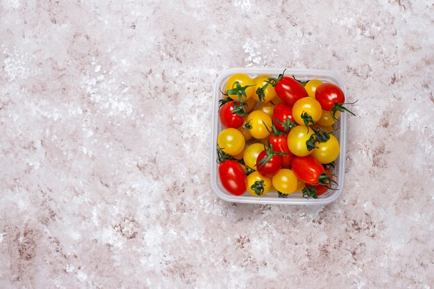 Cherry tomatoes of various colors,yellow and red cherry tomatoes on light background