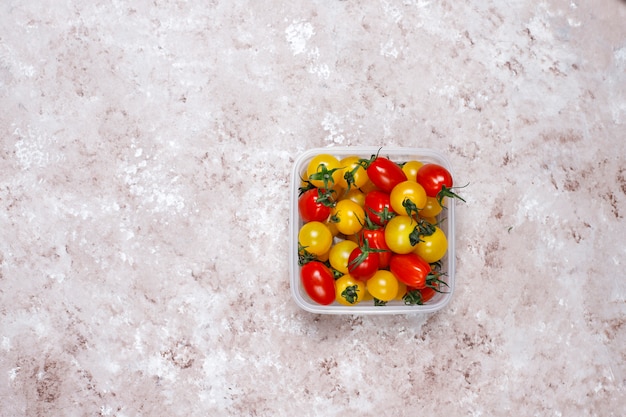 Cherry tomatoes of various colors,yellow and red cherry tomatoes on light background