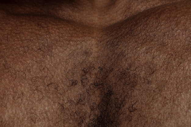 Chest. Detailed texture of human skin. Close up shot of young african-american male body. Skincare, bodycare, healthcare, hygiene and medicine concept. Looks beauty and well-kept. Dermatology.