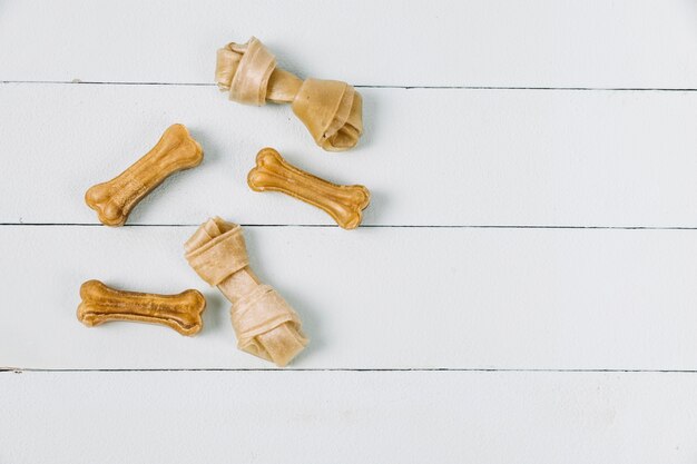 Chewing bones on wooden tabletop